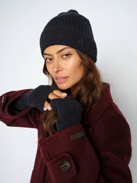 Model wears Mos Mosh dark navy Tova hat and mittens from The Shoe Gallery