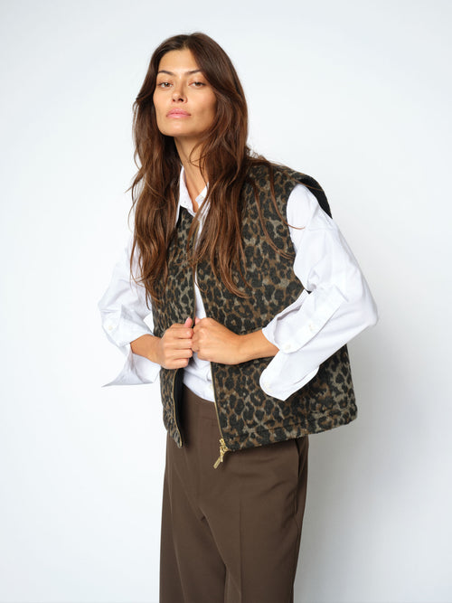 Model wears a Mos Mosh leopard print vest with gold zip detail over a white shirt available at The SHOE GALLERY