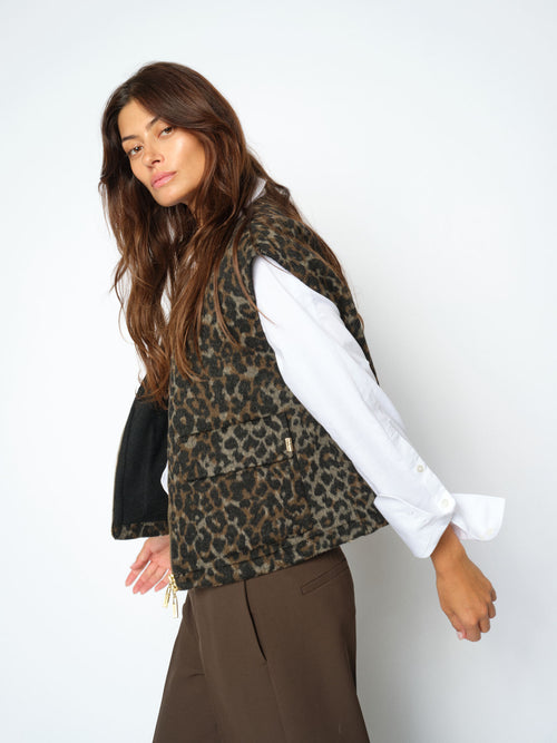 Model wears a Mos Mosh leopard print vest with gold zip detail over a white shirt available at The SHOE GALLERY