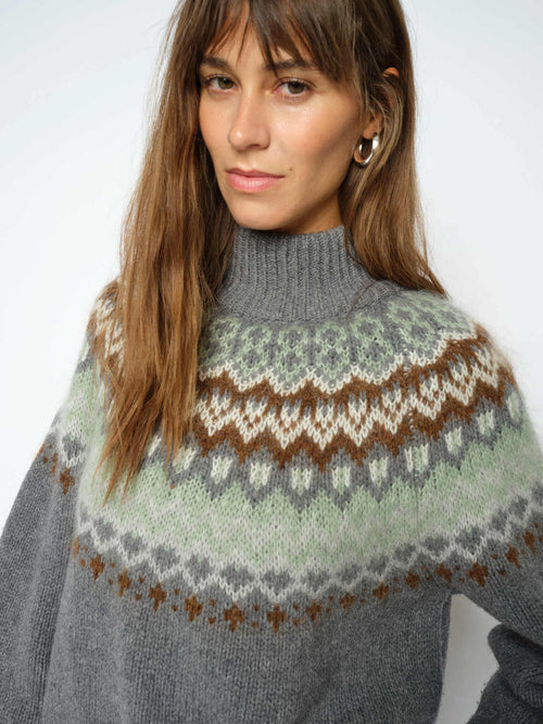 Model wears the Mos Mosh Daya Fjord sweater featuring a jacquard brown and green fairisle patter on grey from The SHOE GALLERY