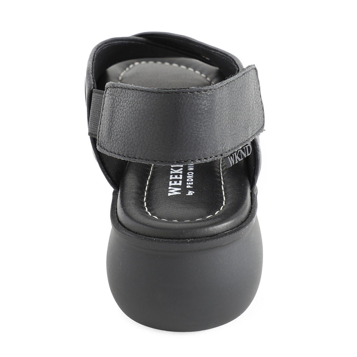 soft leather open toe black sandals with back strap with velcro closure on a cushioned small platform sole. Back view