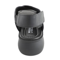 soft leather open toe black sandals with back strap with velcro closure on a cushioned small platform sole. Back view