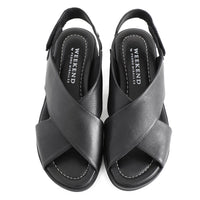 soft leather open toe black sandals with back strap with velcro closure on a cushioned small platform sole. Overhead viewpoint.
