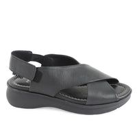 soft leather open toe black sandals with back strap with velcro closure on a cushioned small platform sole. Side view
