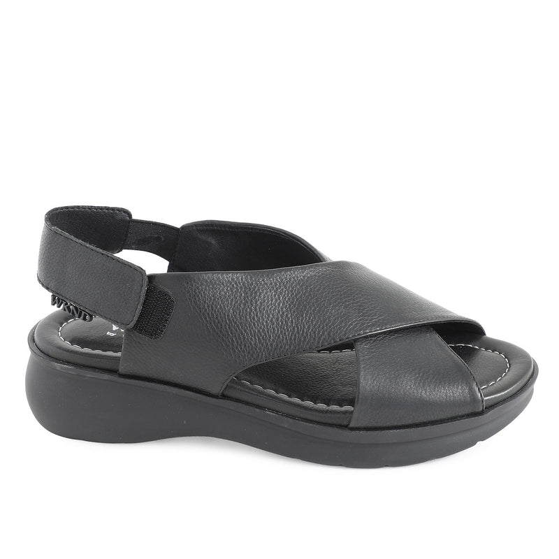 soft leather open toe black sandals with back strap with velcro closure on a cushioned small platform sole. Side view