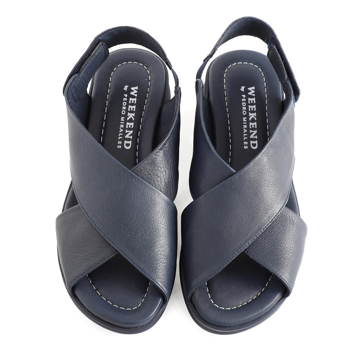 soft leather navy sandals with velcro fastening and cushioned navy slightly platformed sole. An overhead image