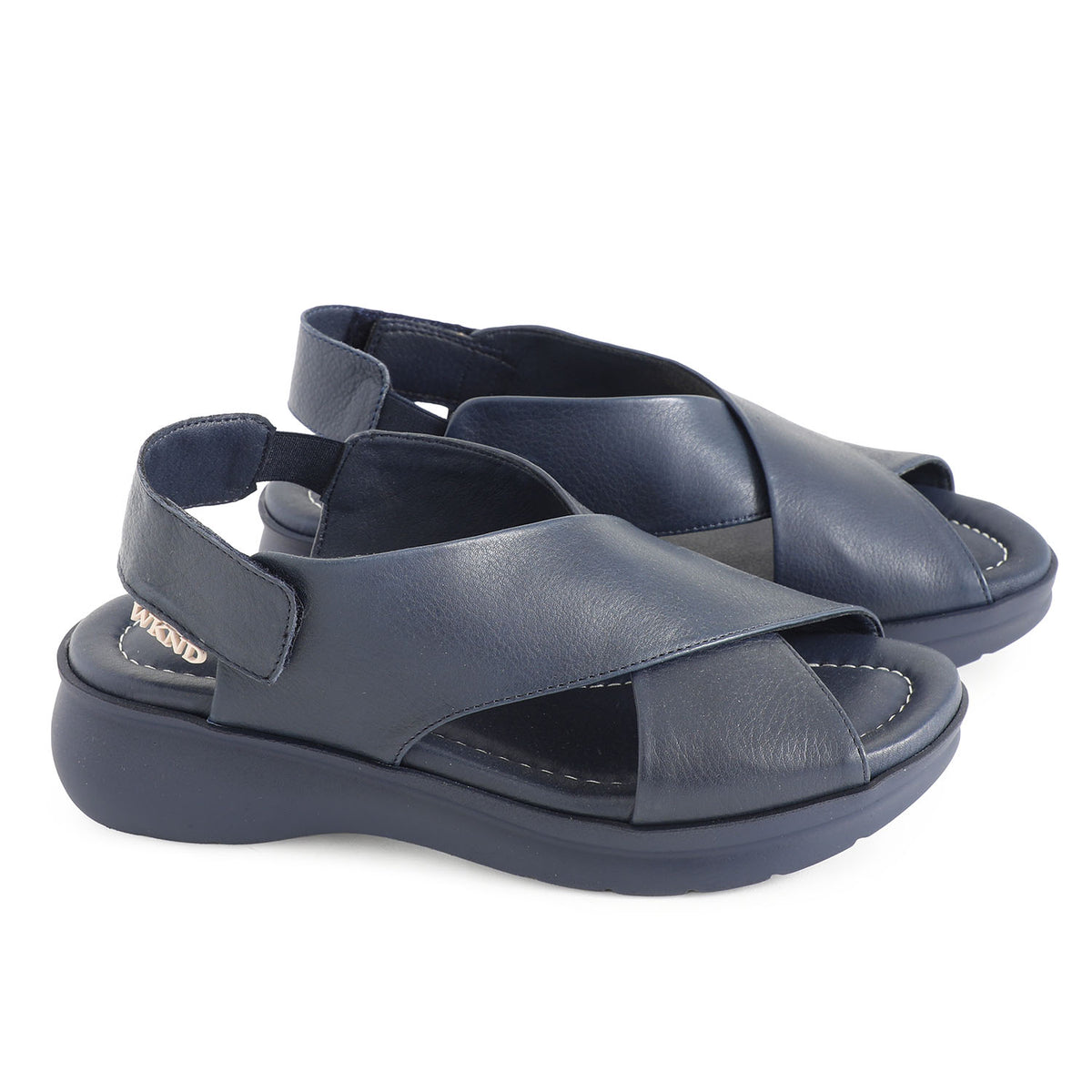 soft leather navy sandals with velcro fastening and cushioned navy slightly platformed sole.