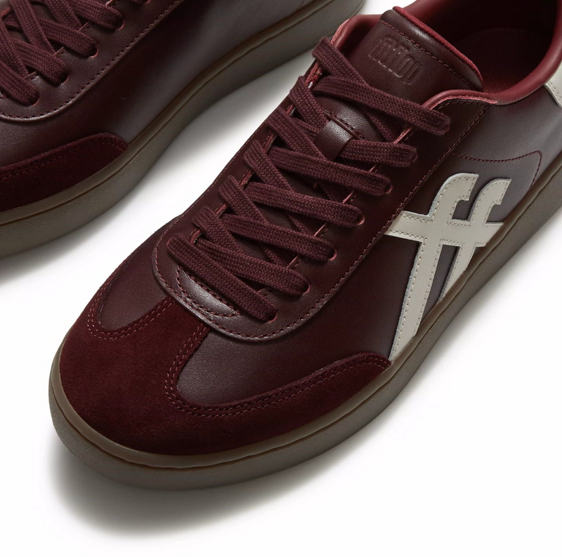 FitFlop Dash Trainer  in dark merlot leather with suede toe and cream toned fitflop branding on the side and at the heel.