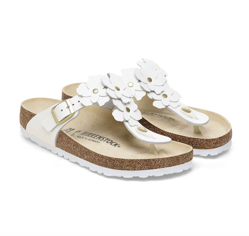 A pair of Birkenstock white leather flower embellished sandals with buckle closure