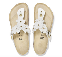 A pair of Birkenstock white leather flower embellished sandals with buckle closure