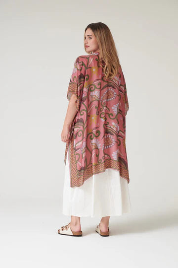 Model wears a One Hundred Stars Giant Kantha Throwover over a swimsuit, back view