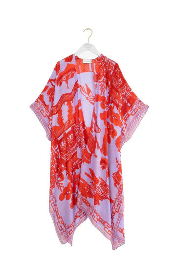 One Hundred Stars Giant Willow throwover in bright red and lilac on a hanger. Available at theshoegallery.co.uk