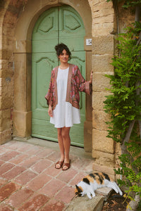 Model wears the Giant Kantha Dsk Kimono by One Hundred Stars available at The SHOE GALLERY over a white dress