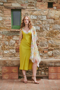 Model wears a One Hundred Stars Giant Kantha Throwover over a lime dress