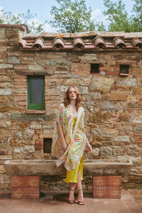 Model wears a One Hundred Stars Giant Kantha Throwover in lime over a dress