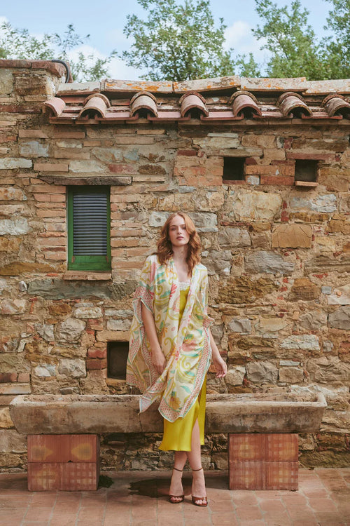 Model wears a One Hundred Stars Giant Kantha Throwover in lime over a dress