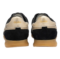 A pair of Gola black and metallic gold sneakers shown from the back, featuring a black suede heel section, a metallic gold leather heel counter with the brand name 'Gola' in gold lettering, and a tan gum sole. Available at The SHOE GALLERY