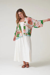 Model wears a One Hundred Stars Kitsch Bouquet Kimono over a white dress