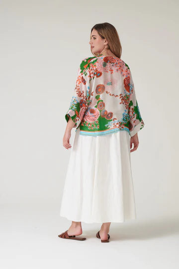Model wears a One Hundred Stars Kitsch Bouquet Kimono over a white dress