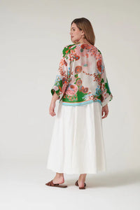 Model wears a One Hundred Stars Kitsch Bouquet Kimono over a white dress