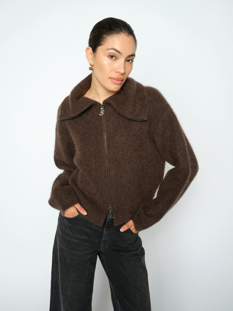 Model wears a brown mohair mix zip-up jacket with a wide collar and dark wide-leg jeans