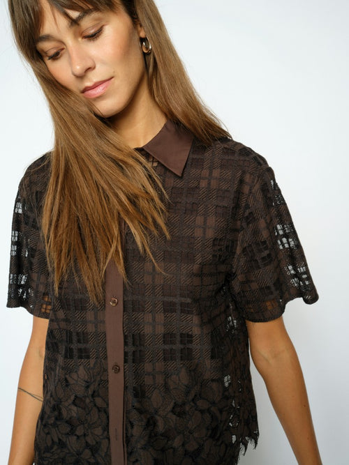Model wears a Mos Mosh brown lace short shirt against a white background
