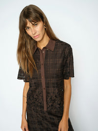 Model wears a Mos Mosh brown lace short shirt against a white background