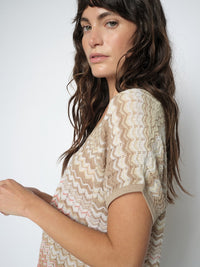 Lady wearing Zig zag striped sleeveless top in cream, taupe and coral