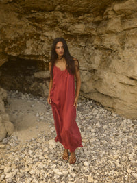 Model wears full length slip dress with lace neckline in terracotta