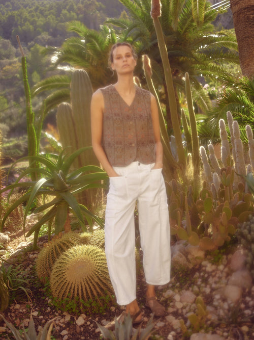 model wears white cotton denim barrel jeans