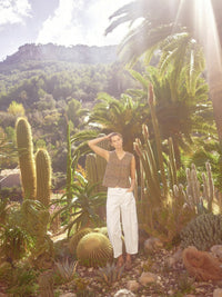 model wears white cotton denim barrel jeans