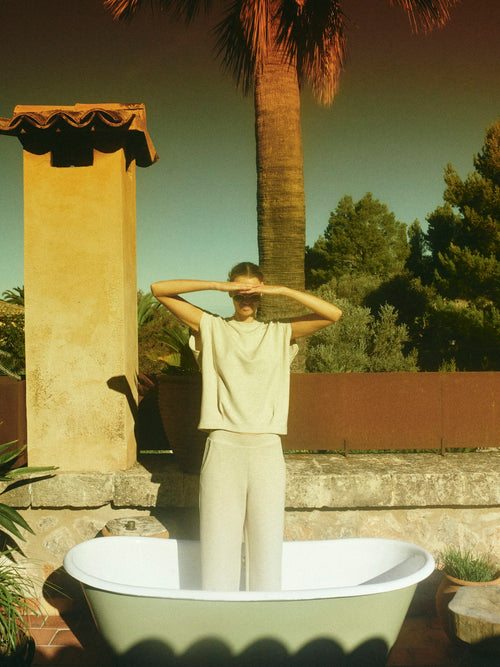 Model wears relaxed fit sleeveless sweatshirt