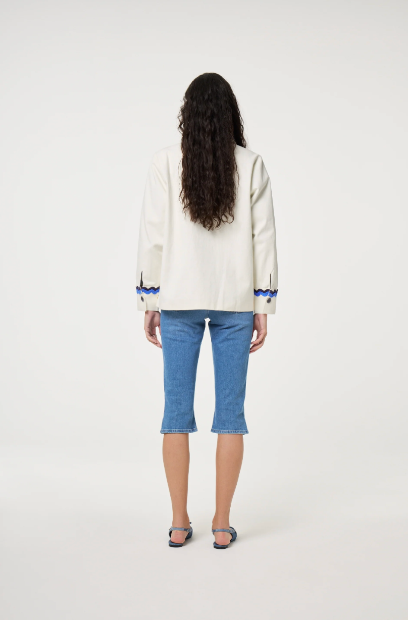 Fabienne Chapot cream Melodie jacket with double rick rack in blue and navy edging the collar, pockets, sleeves and central closure, back view