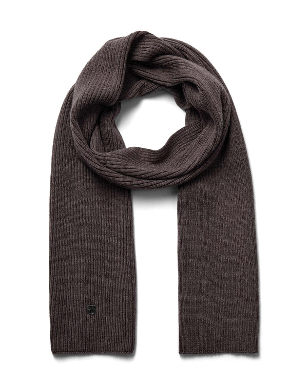A brown toned ribbed Mos Mosh wool knit scarf, neatly folded and looped to display its texture and length, with a discreet logo on one end available at The Shoe Gallery