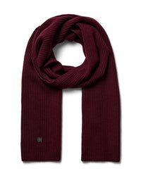 A burgandy toned ribbed Mos Mosh wool knit scarf, neatly folded and looped to display its texture and length, with a discreet logo on one end available at The Shoe Gallery