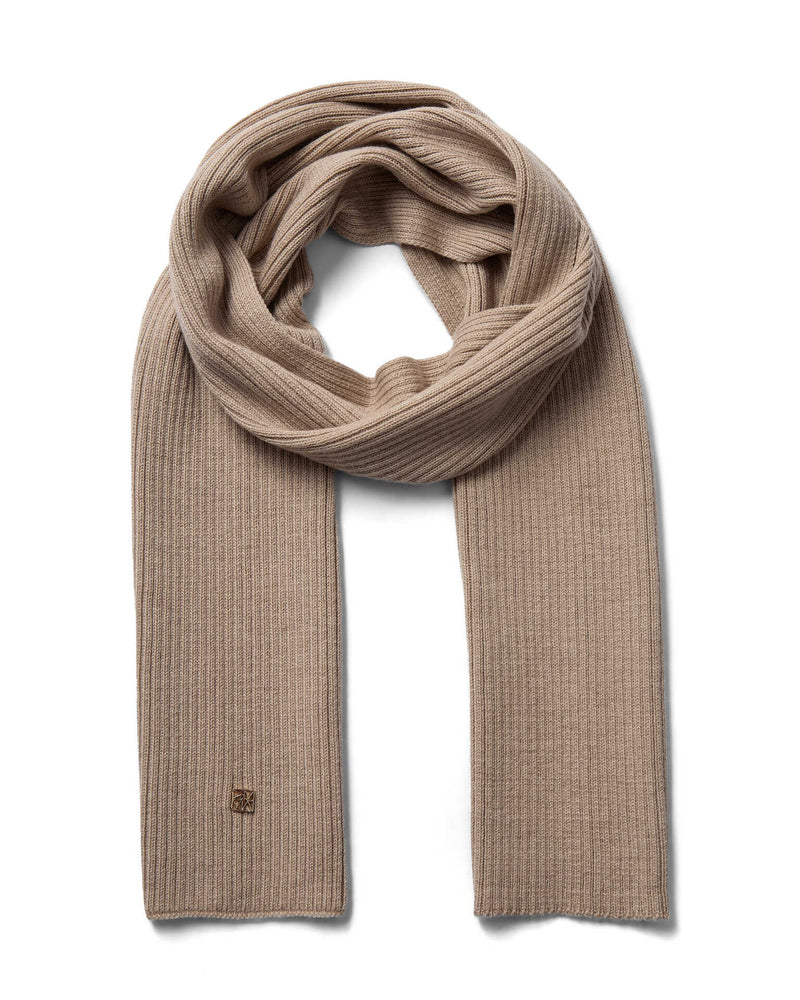 A beige toned ribbed Mos Mosh wool knit scarf, neatly folded and looped to display its texture and length, with a discreet logo on one end available at The Shoe Gallery