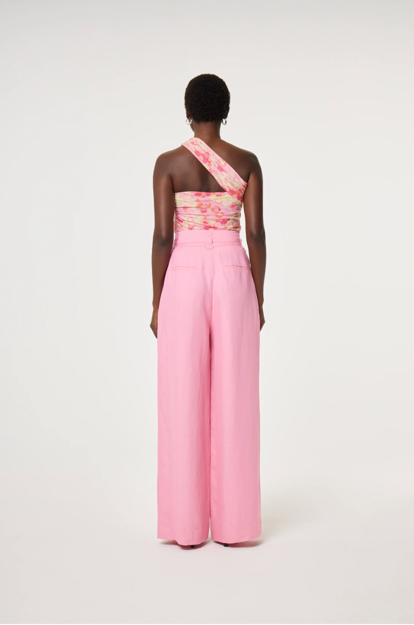 Model wearing a floral one-shoulder top and pink linen mix Fabienne Chapot wide-leg pants with corsage belt, back view