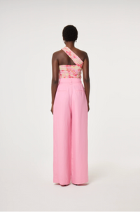 Model wearing a floral one-shoulder top and pink linen mix Fabienne Chapot wide-leg pants with corsage belt, back view