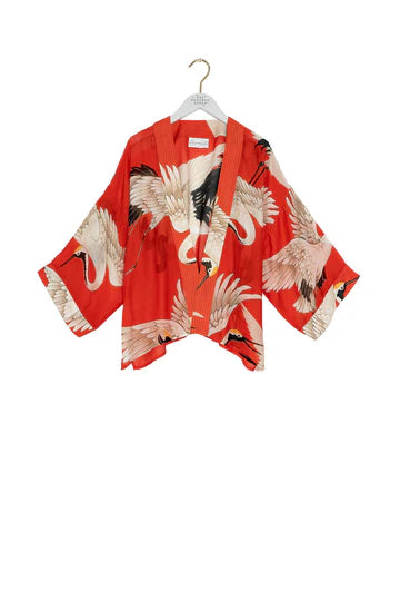One Hundred Stars Kimono in the crane print in scarlet on hanger