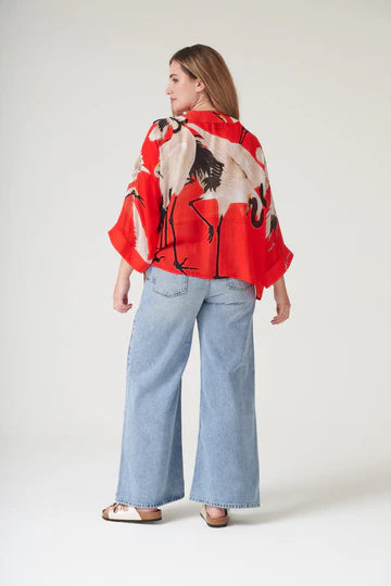 Model wears a One Hundred Stars Kimono in the crane print in scarlet