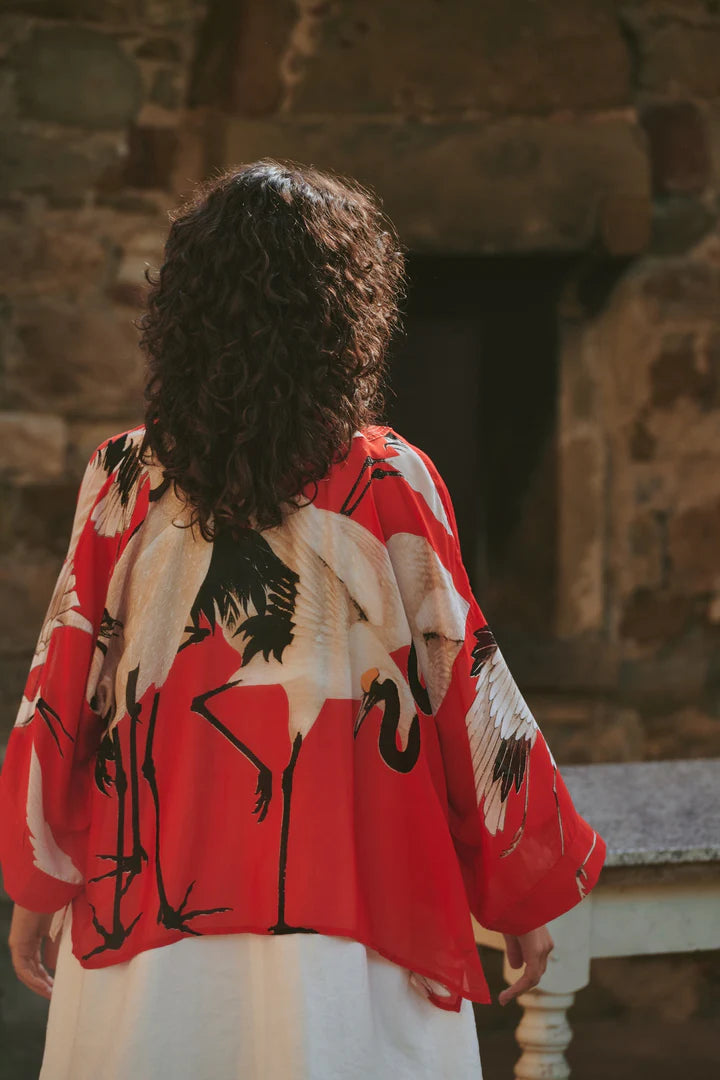 Model wears a One Hundred Stars Kimono in the crane print in scarlet, back view