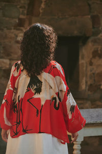 Model wears a One Hundred Stars Kimono in the crane print in scarlet, back view
