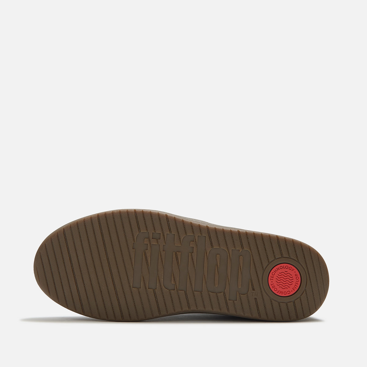 The brown gum sole of the FitFlop Dash navy blue suede and leather sneaker with matching navy laces, a white side stripe, and a brown gum sole, available at The hoe Gallery