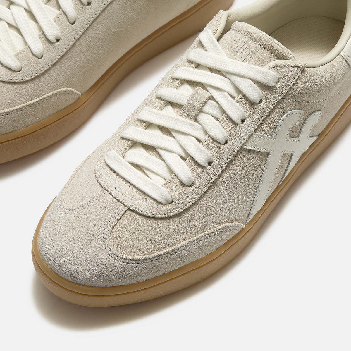 FitFop Dash trainer in Hazy Taupe Suede with off-white laces and branding, and gum soles.