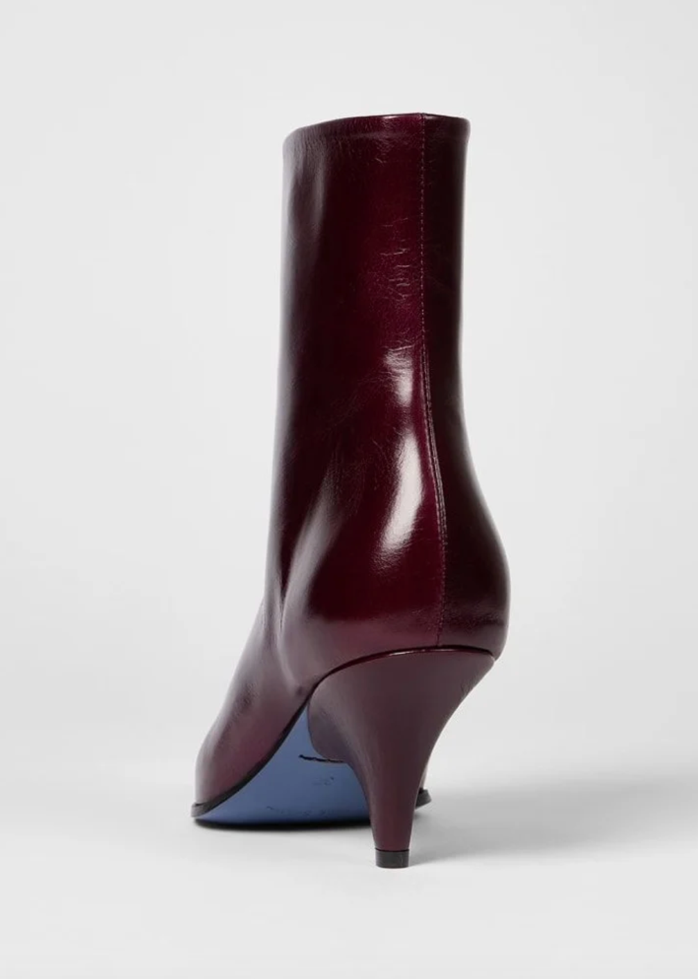 Paul Smith Winnie heel view pointed-toe ankle boots in glossy burgundy leather with gold-tone side zippers and kitten heels, available at The Shoe Gallery