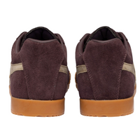 A pair of low-top Gola suede sneakers shown from the back, featuring a dark plum-brown upper with a light gold side stripe and a gum brown sole, available at The SHOE GALLERY