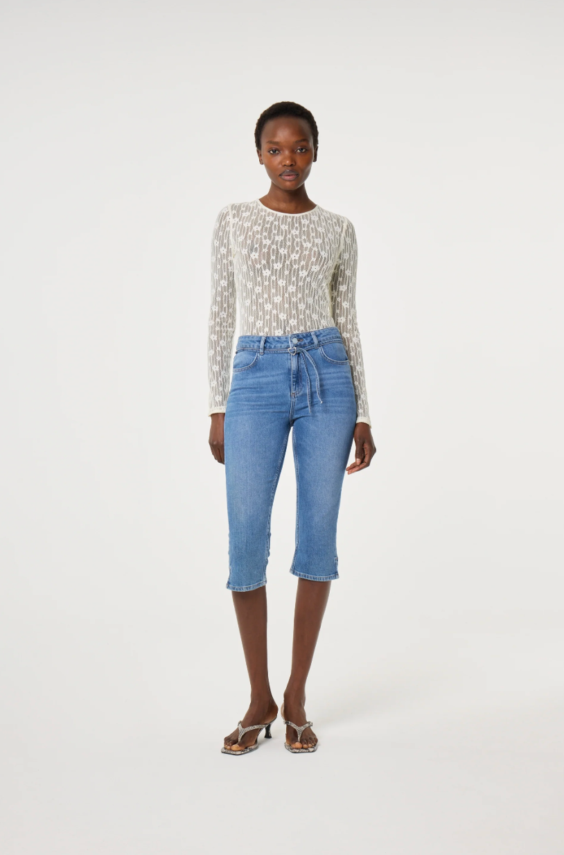 Model wearing a patterned long-sleeve cream lacey Fabienne Chapot top