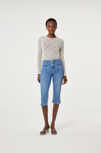 Model wearing a patterned long-sleeve cream lacey Fabienne Chapot top