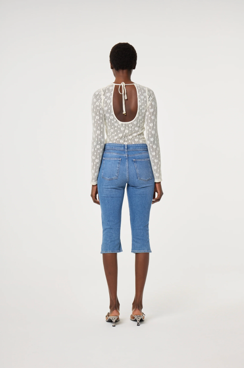 Model wearing a patterned long-sleeve cream lacey Fabienne Chapot top, back view