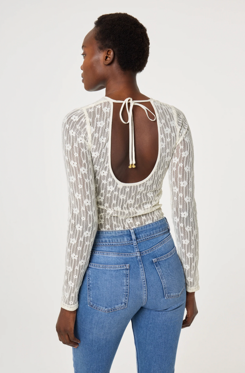 Model wearing a patterned long-sleeve cream lacey Fabienne Chapot top, back view